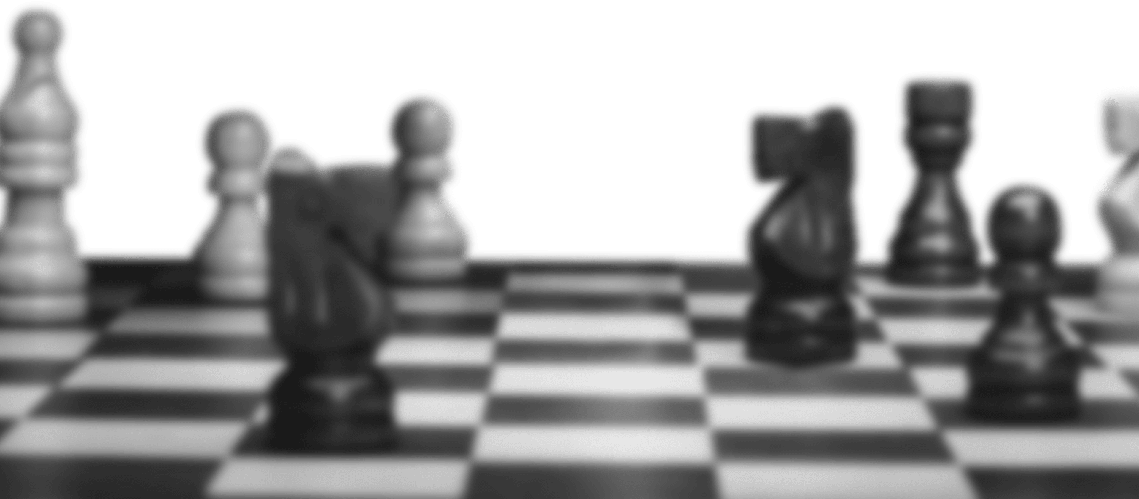 blurred chess board with pieces viewed from angle